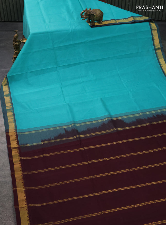 Silk cotton saree teal blue and wine shade with plain body and zari woven border