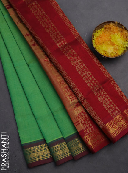 Silk cotton saree green and maroon with plain body and zari woven border