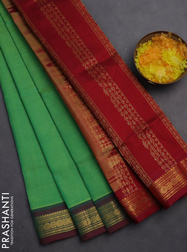 Silk cotton saree green and maroon with plain body and zari woven border