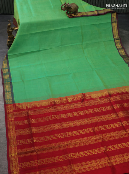 Silk cotton saree green and maroon with plain body and zari woven border