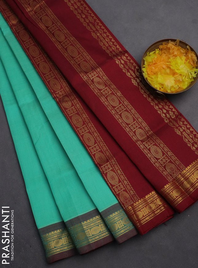 Silk cotton saree teal green and maroon with plain body and zari woven border