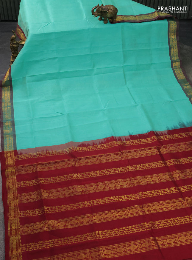Silk cotton saree teal green and maroon with plain body and zari woven border