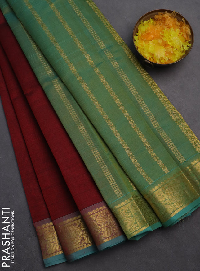 Silk cotton saree maroon and teal green with plain body and zari woven border
