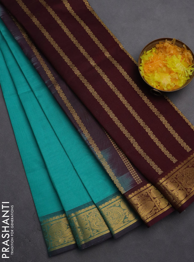 Silk cotton saree teal green and deep maroon with plain body and zari woven border