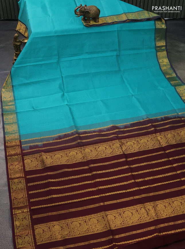 Silk cotton saree teal green and deep maroon with plain body and zari woven border
