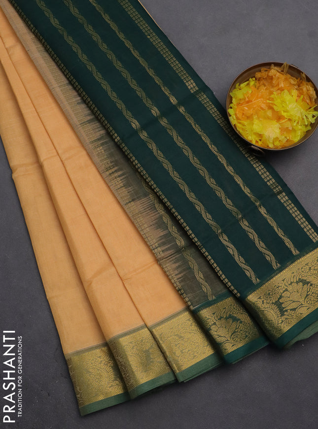 Silk cotton saree pale orange and green with plain body and zari woven border