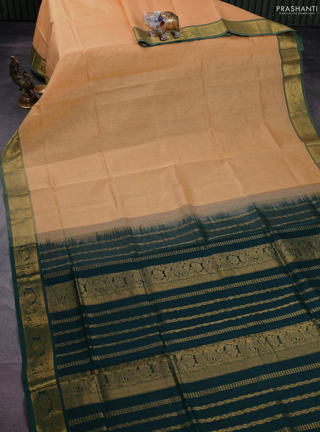 Silk cotton saree pale orange and green with plain body and zari woven border