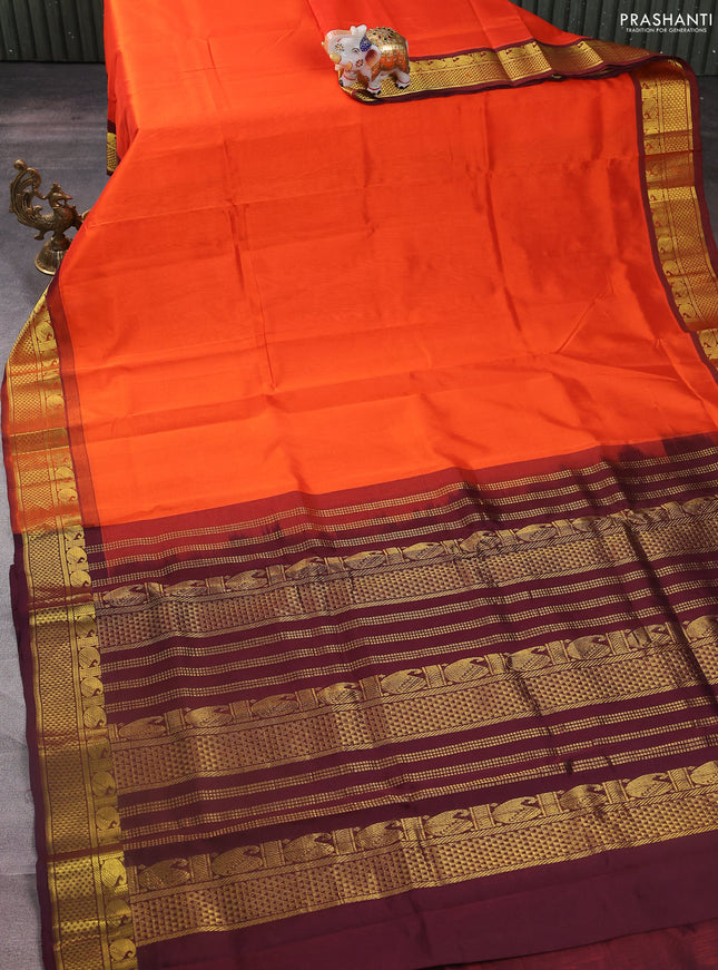 Silk cotton saree orange and deep maroon with plain body and zari woven border