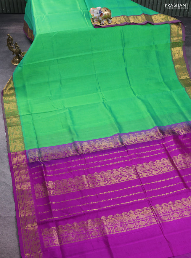 Silk cotton saree light green and purple with plain body and zari woven border