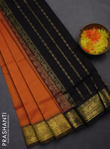 Silk cotton saree orange and black with plain body and zari woven border
