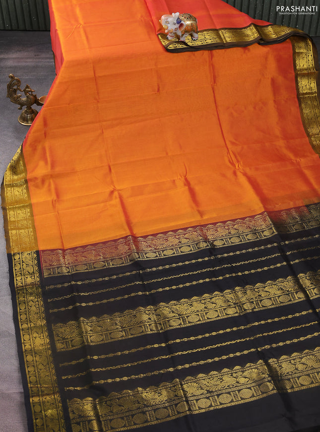 Silk cotton saree orange and black with plain body and zari woven border