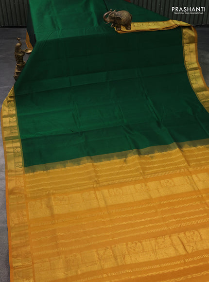 Silk cotton saree green and mustard yellow with plain body and zari woven border