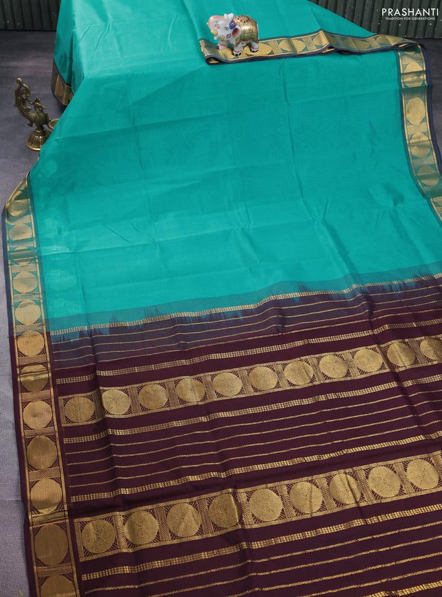 Silk cotton saree teal blue and brown with plain body and zari woven border