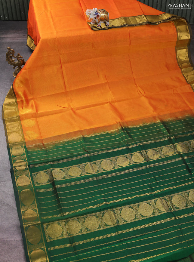 Silk cotton saree orange and green with plain body and zari woven border