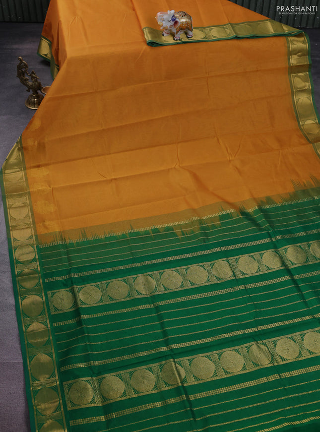 Silk cotton saree mustard yellow and green with plain body and zari woven border