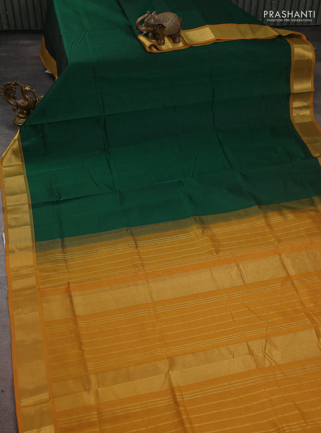 Silk cotton saree green and mustard yellow with plain body and zari woven border