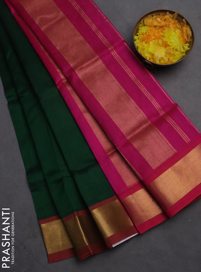 Silk cotton saree green and magenta pink with plain body and zari woven border
