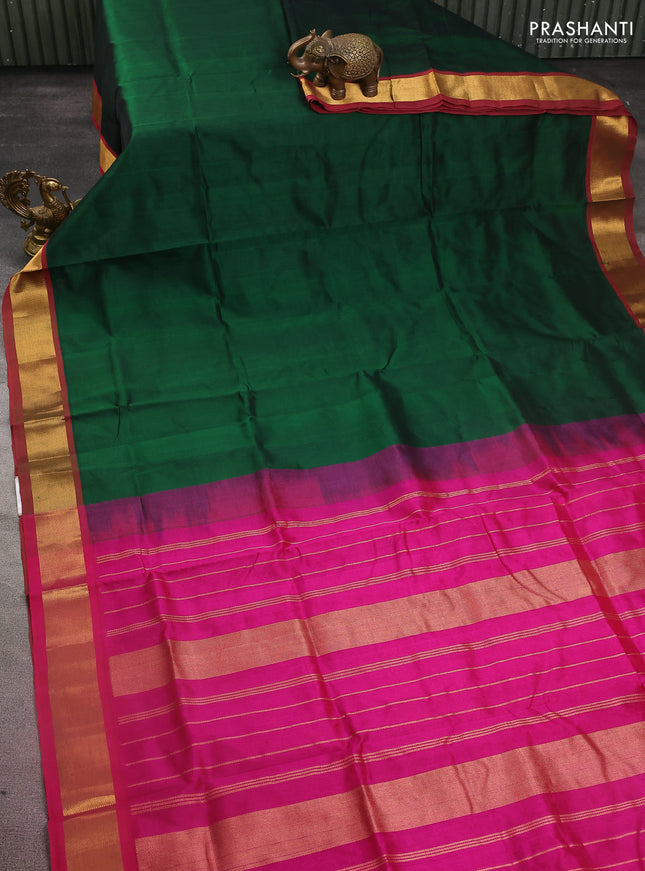 Silk cotton saree green and magenta pink with plain body and zari woven border