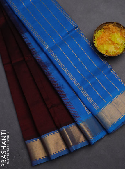 Silk cotton saree deep maroon and cs blue with plain body and zari woven border