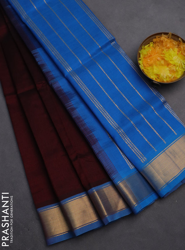 Silk cotton saree deep maroon and cs blue with plain body and zari woven border