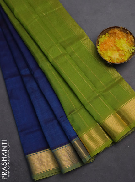 Silk cotton saree peacock blue and light green with plain body and zari woven border