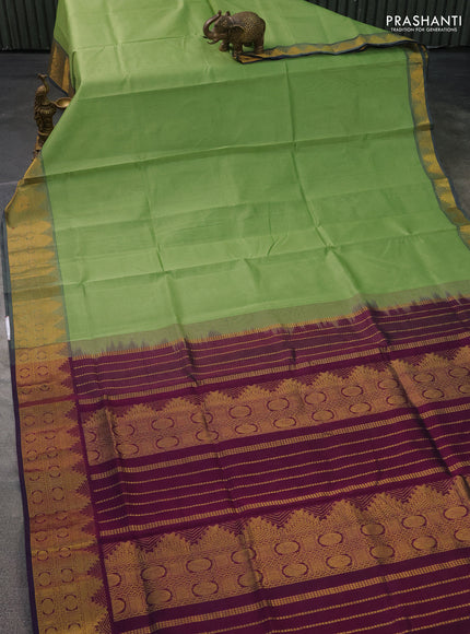 Silk cotton saree pista green and wine shade with plain body and zari woven border
