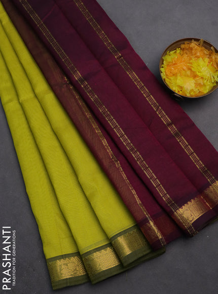 Silk cotton saree lime yellow and purple with plain body and zari woven border