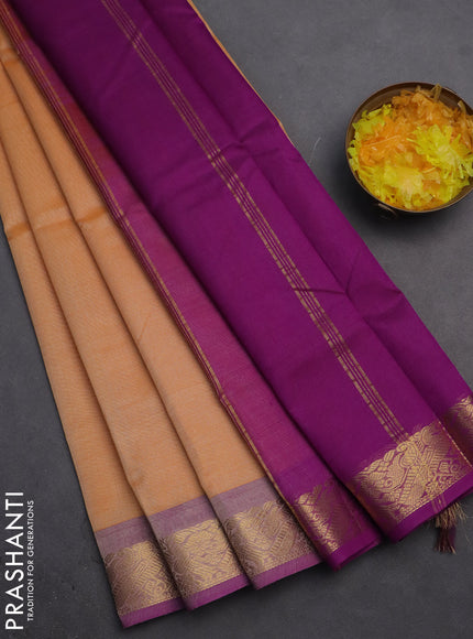Silk cotton saree pale orange and purple with plain body and zari woven border