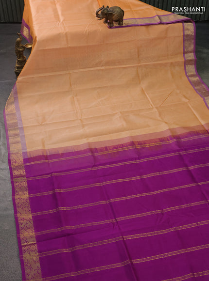Silk cotton saree pale orange and purple with plain body and zari woven border