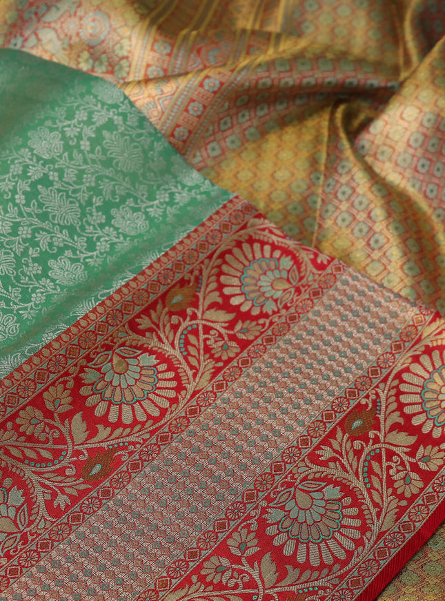 Pure Kanchipuram tissue silk saree dual shade of teal and red with allover silver zari woven brocade weaves and long zari woven border