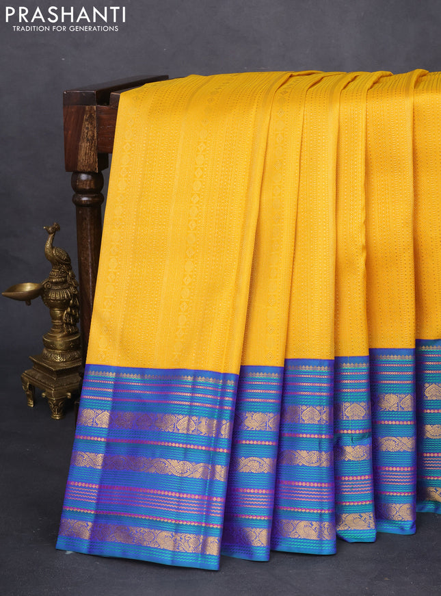 Pure kanchipuram silk saree yellow and peacock blue with allover zari woven brocade weaves and zari woven korvai border
