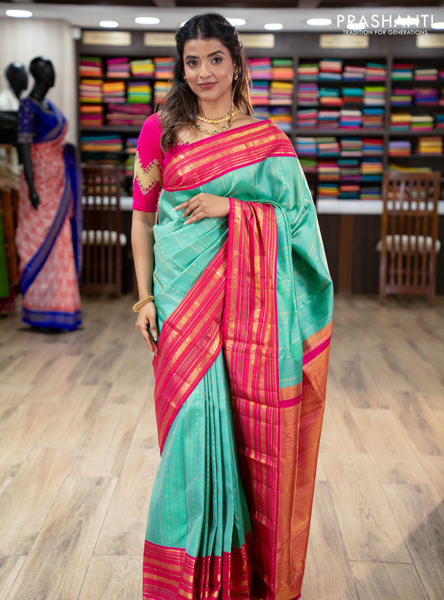 Pure kanchipuram silk saree teal green and pink with allover zari woven brocade weaves and zari woven korvai border