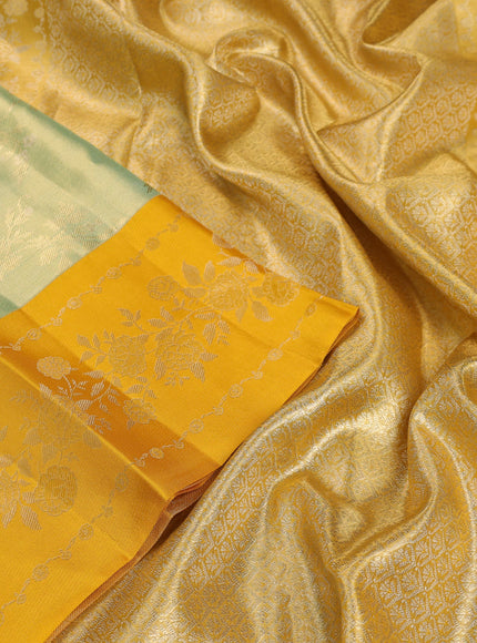 Pure kanchipuram Tissue silk saree pista green and mustard yellow with allover zari weaves and floral design zari border