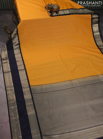 Semi kanchipuram silk saree mango yellow and dark navy blue with allover zari woven stripes pattern and rettapet zari woven korvai border