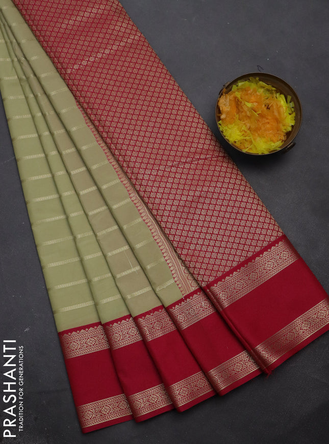 Semi kanchipuram silk saree mild pista green and pink with allover zari woven stripes pattern and rettapet zari woven korvai border