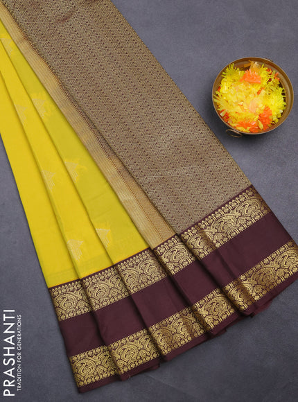 Semi kanchipuram silk saree lime yellow and coffee brown with zari woven buttas and rettapet zari woven korvai border