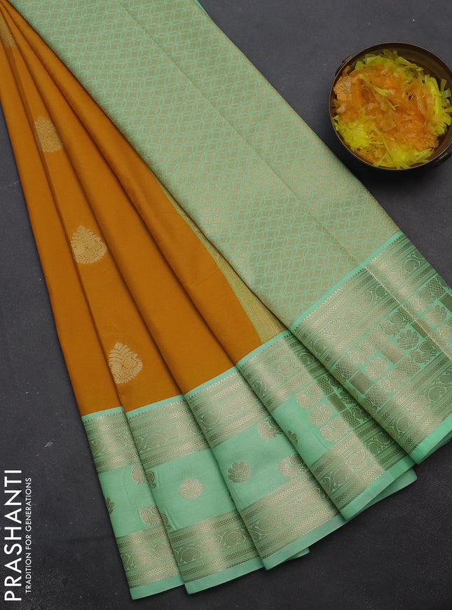 Semi kanchipuram silk saree mustard yellow and teal green with zari woven buttas and rettapet zari woven korvai border
