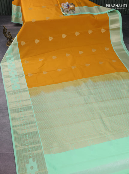 Semi kanchipuram silk saree mustard yellow and teal green with zari woven buttas and rettapet zari woven korvai border
