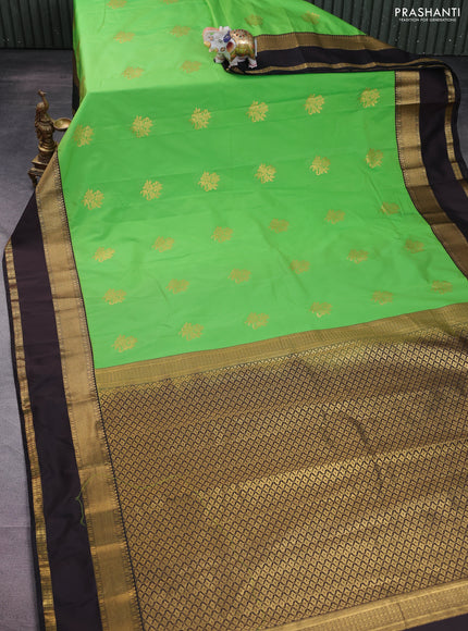 Semi kanchipuram silk saree light green and deep coffee brown with floral zari woven buttas and rettapet zari woven korvai border