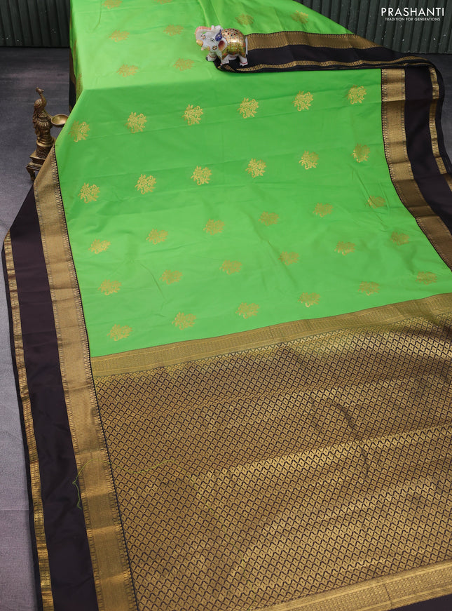 Semi kanchipuram silk saree light green and deep coffee brown with floral zari woven buttas and rettapet zari woven korvai border