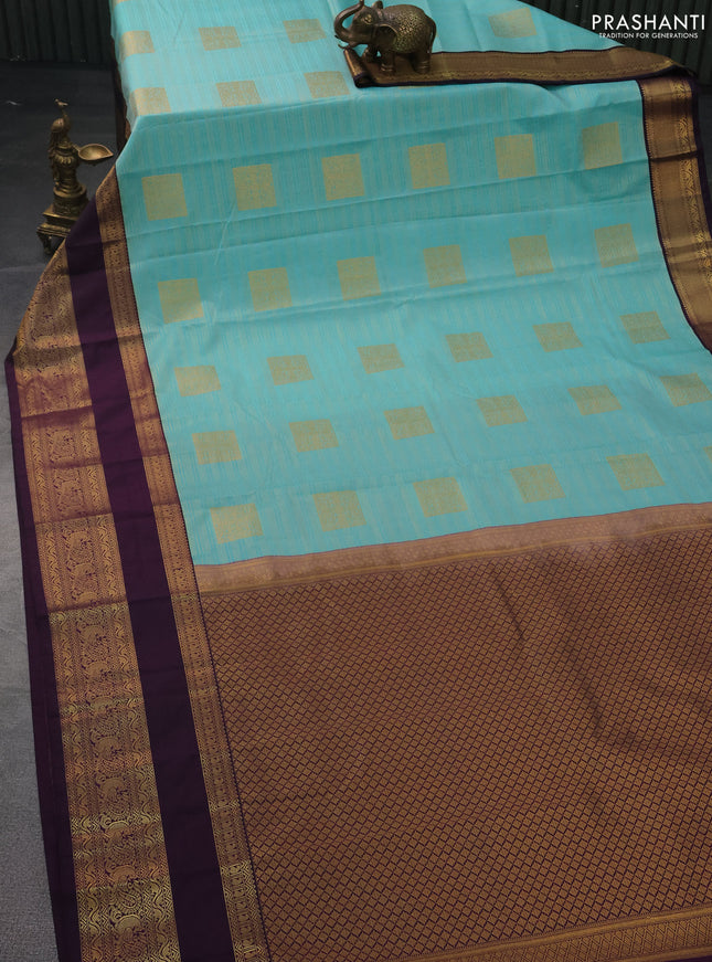 Semi kanchipuram silk saree teal blue and deep purple with allover zari weaves & buttas and rettapet zari woven korvai border