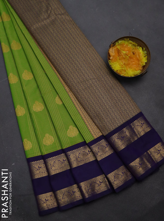 Semi kanchipuram silk saree light green and navy blue with allover small zari checks & buttas and rettapet zari woven korvai border
