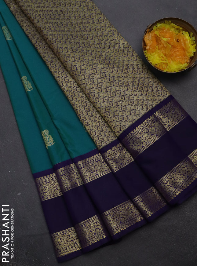 Semi kanchipuram silk saree dual shade of teal blue and navy blue with zari woven buttas and rettapet zari woven korvai border