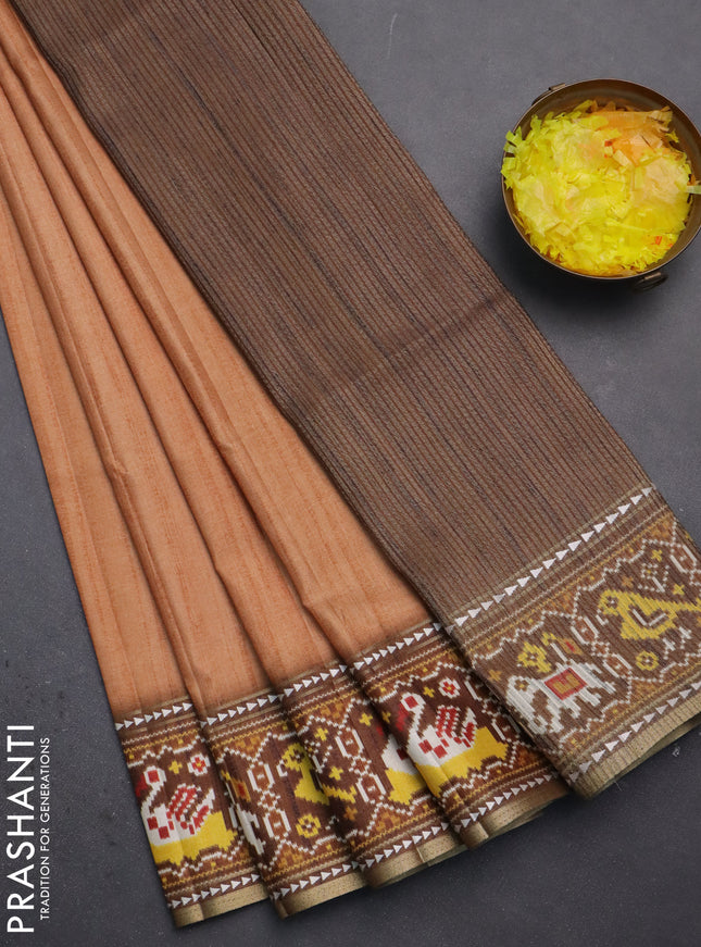 Semi tussar saree peach orange and brown with plain body and patola printed border