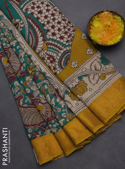 Kalamkari semi silk saree teal green and mustard yellow with allover prints and zari woven border
