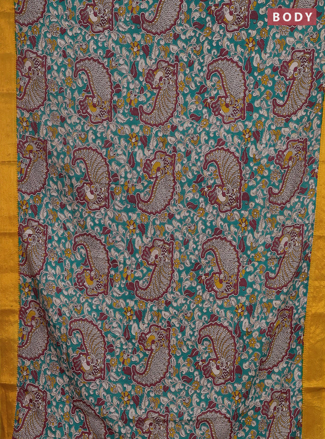 Kalamkari semi silk saree teal green and mustard yellow with allover prints and zari woven border