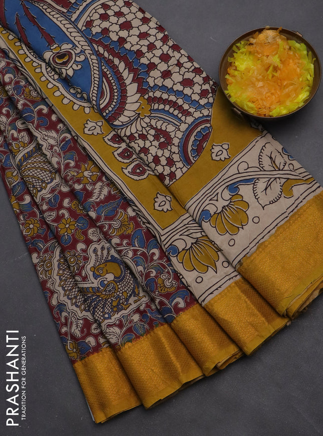 Kalamkari semi silk saree maroon and mustard yellow with allover prints and zari woven border