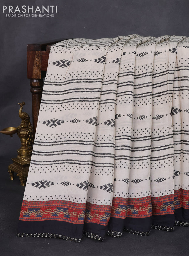 Crepe silk saree cream and black with patola prints & embroidery mirror work pallu