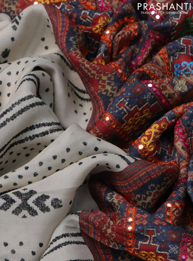 Crepe silk saree cream and black with patola prints & embroidery mirror work pallu