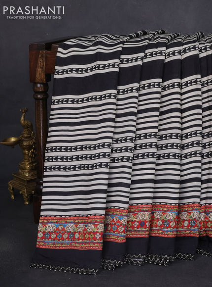 Crepe silk saree off white black and pastel violet with patola prints & embroidery mirror work pallu